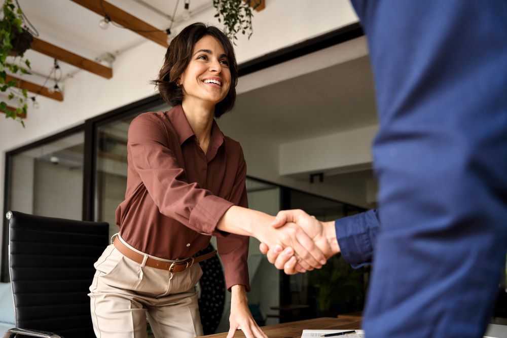 Woman shaking her advisor's hand