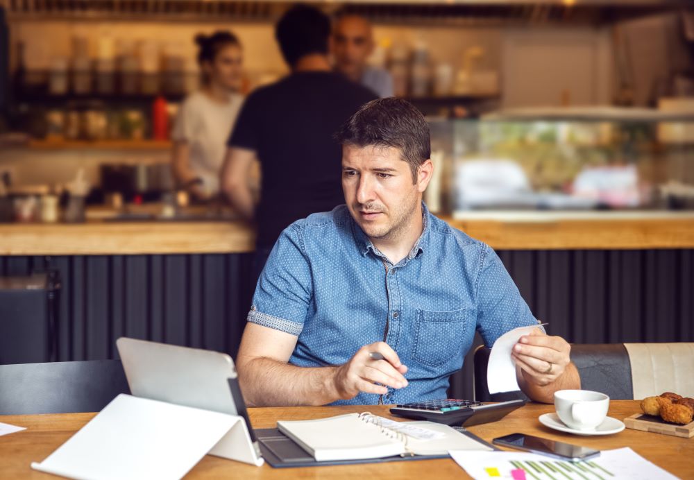 Business owner reviewing bills 