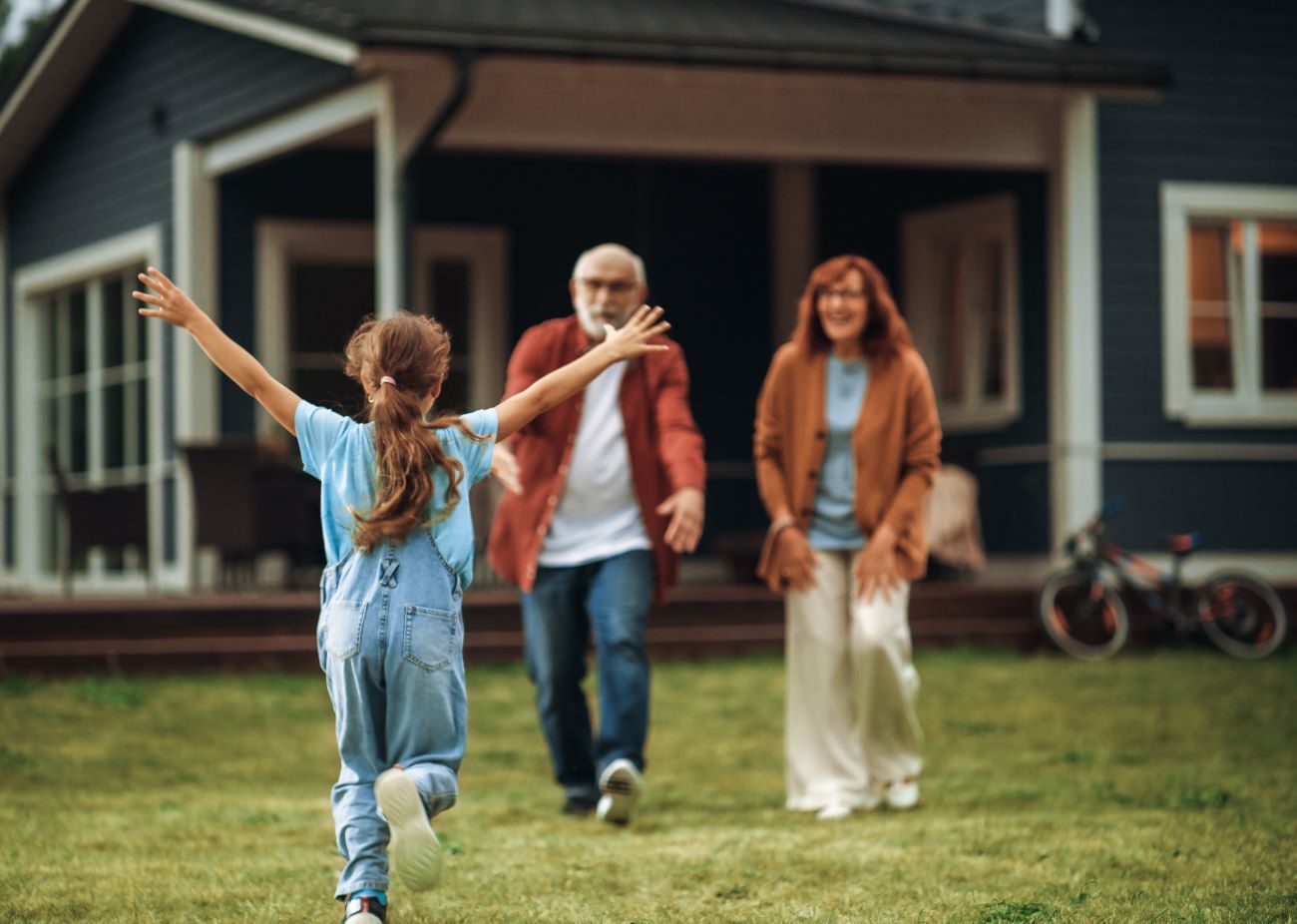Grandchild running toward her grandparents 