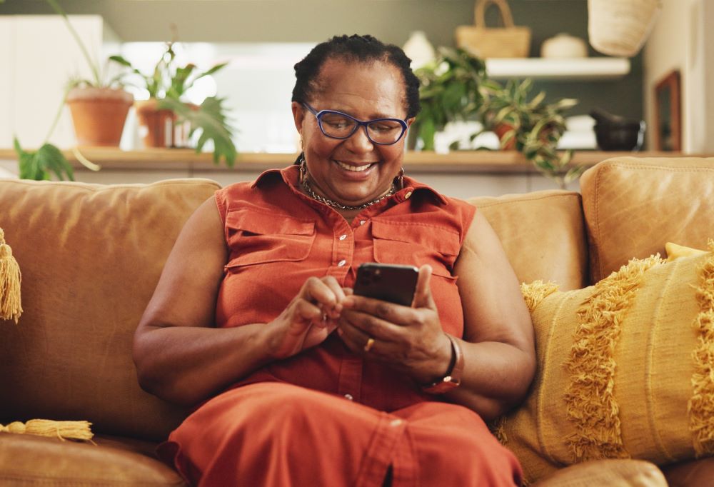 Senior woman smiling looking at her phone 