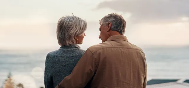 senior couple outdoor on balcony of home together